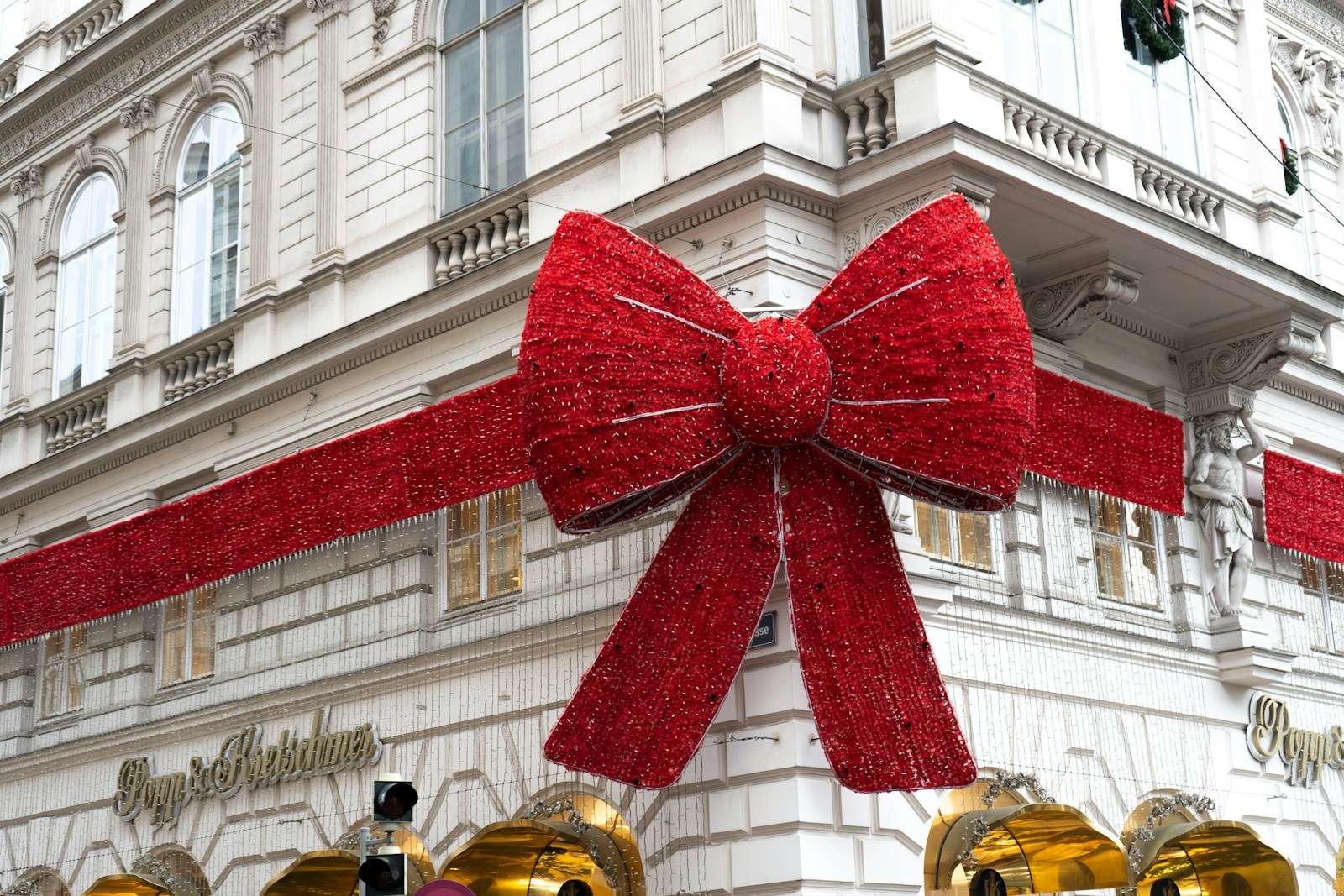 a large red bow hanging from the side of a building